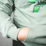 An animated GIF showing someone removing the fidget pouch from the front pocket of their Fidget Hoodie.