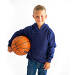 A child wears the Navy Youth Fidget Hoodie and holds a basketball.