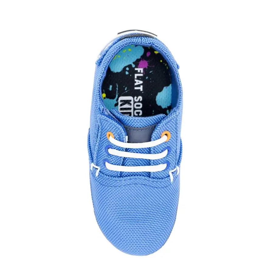 An aerial view of the Kids Paint Splatter Flat Sock in a blue toddler shoe.