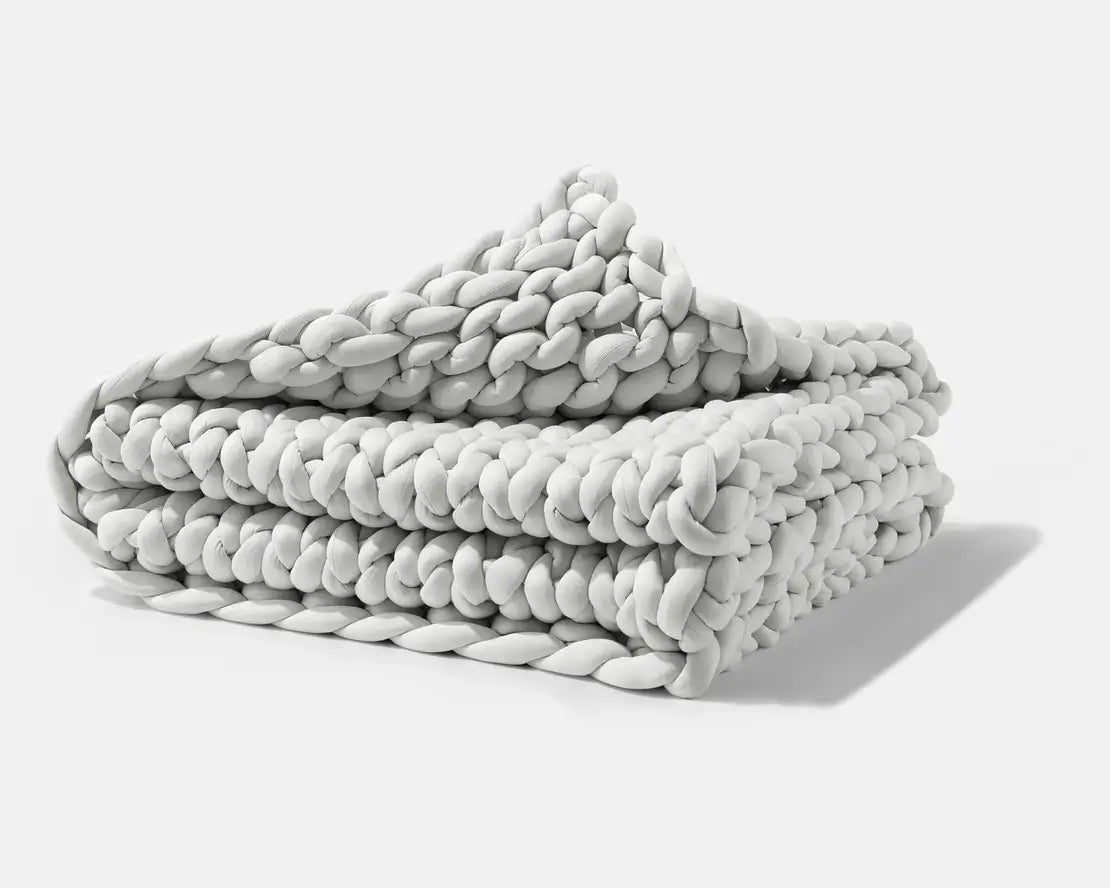 A folded Soft Grey Gravity Chunky Knit Weighted Blanket.