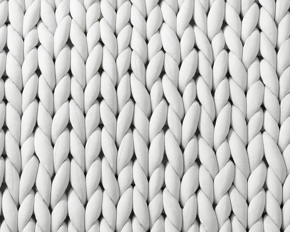 An up-close shot of the folded knits of the Soft Grey Chunky Knit Weighted Blanket.