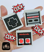 The 3 variants of Retro Game Controller Fidget Clicker Keychains.