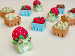 A variety of clickers, which include the Strawberry Frog Clicker Fidget Keychain.