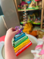 A hand touches the top two blocks on a stack of 10-Piece Crystal Clear Pyramid Lucite Blocks.
