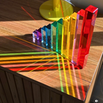 Light refracting from the 10-Piece Crystal Clear Pyramid Lucite Blocks.