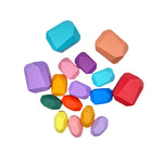 The 16-Piece Wooden Balancing Stones Stacking Blocks in Pastel Colors scattered about.