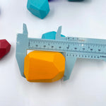 A yellow Stone Stacking Block being measured in a blue device.