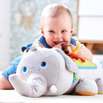 A toddler uses the teething ring on the Baby Elephant Discover Sensory Pillow.
