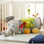The Baby Elephant Discovery Sensory Pillow in a crib.