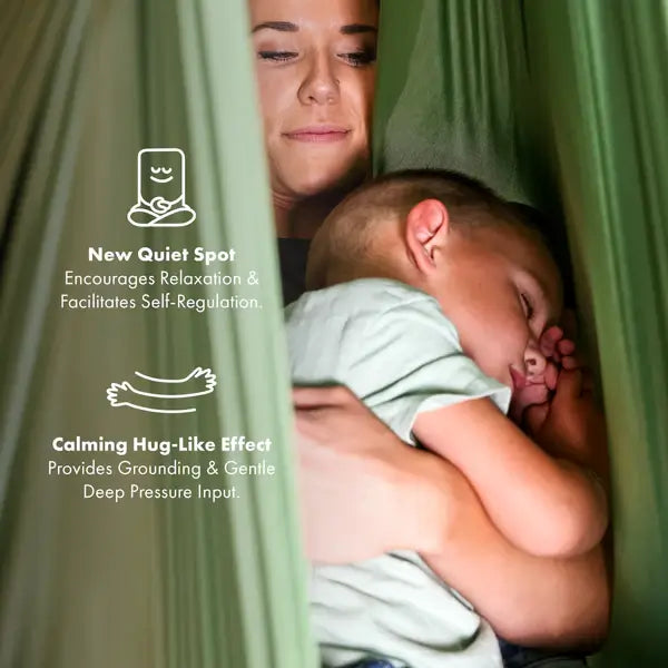A child hugs an adult while wrapped in the folds of the Harkla Green Sensory Compression Swing with Swivel.