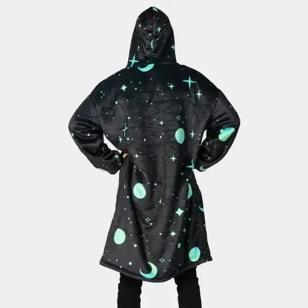 Someone models the backside of the Hideout Hoodie Galactic Glow Wearable Blanket Hoodie .