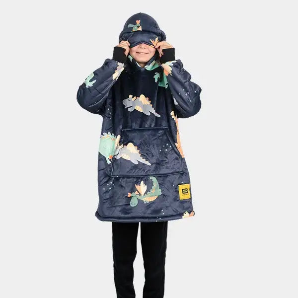 A child pulls on the eye mask built into the hood of the Kids Hideout Hoodie.