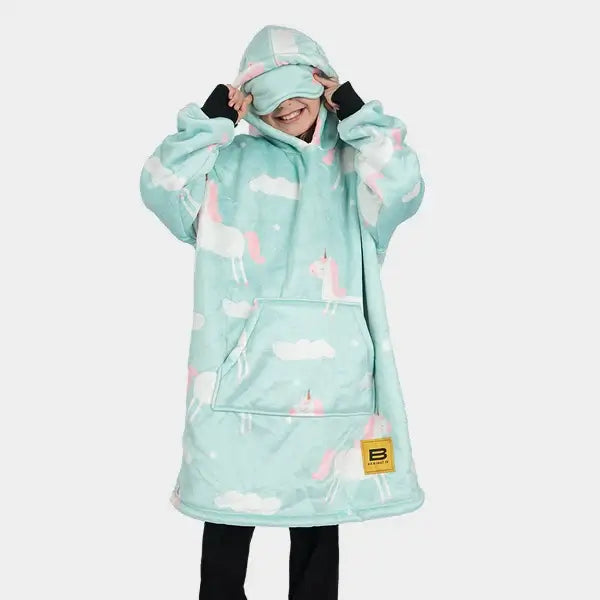 A child pulls on the eye mask attached to the hood of their Unicorn Kids Hideout Hoodie.