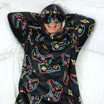 A person lying in bed relaxes with their arms behind their head while wearing the Player 1 Hideout Hoodie.