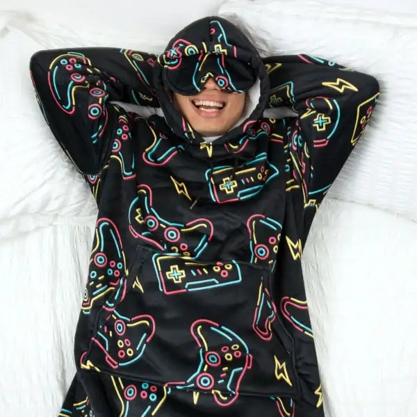 A person lying in bed relaxes with their arms behind their head while wearing the Player 1 Hideout Hoodie.