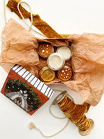 A stylishly put together holiday package with a variety of the Mini KidDoughs, decorated with a beige tissue paper and a brown velvet ribbon.