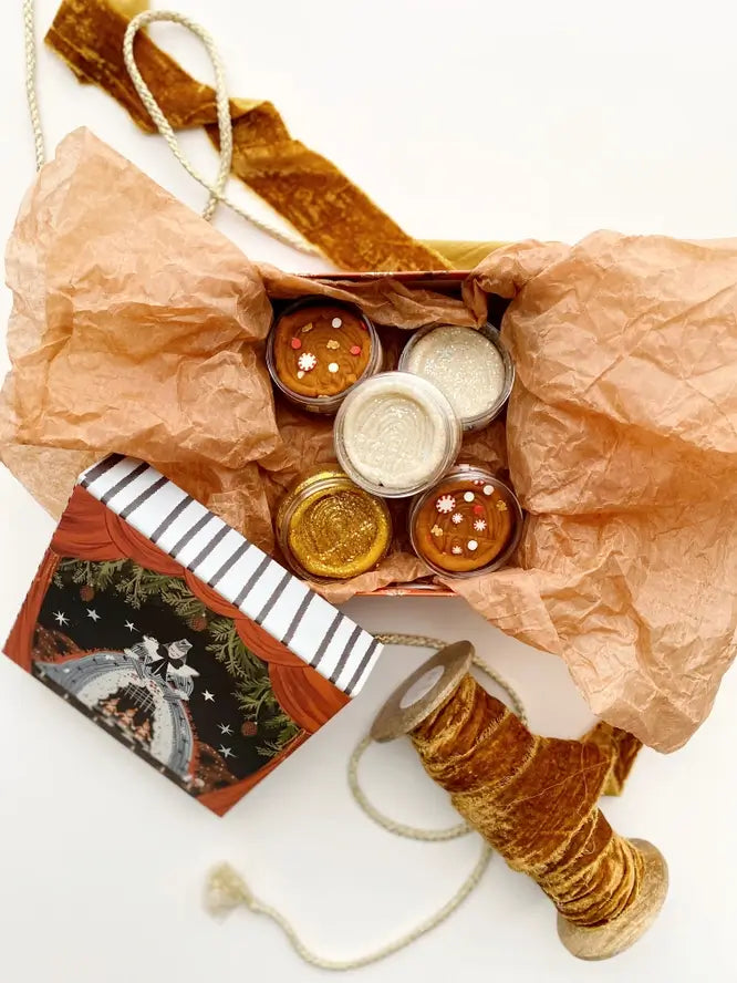 A stylishly put together holiday package with a variety of the Mini KidDoughs, decorated with a beige tissue paper and a brown velvet ribbon.