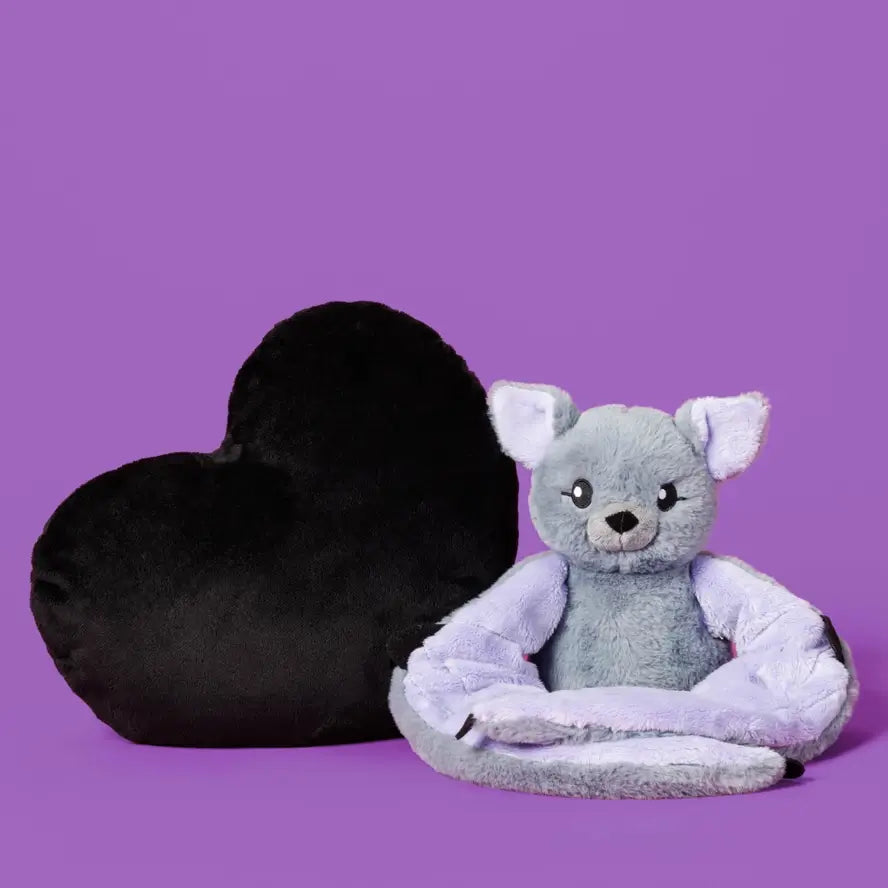 The black Heart to Hug 5 lb Weighted Pillow next to Berkeley the Bat.