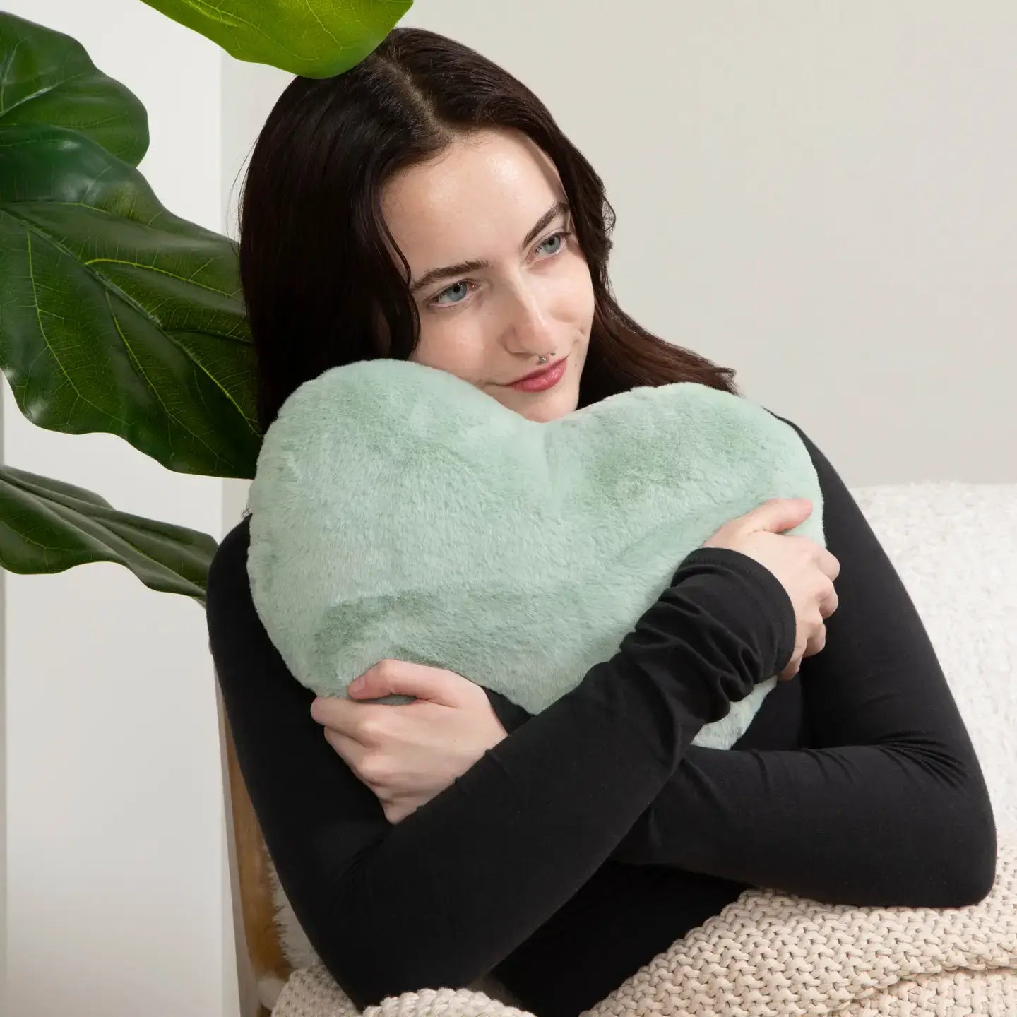 Someone rests their chin on the top of the Sea Glass Heart to Hug Weighted Pillow - 5 lb.