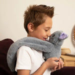 A young child rubs noses with Berkeley the Bat.