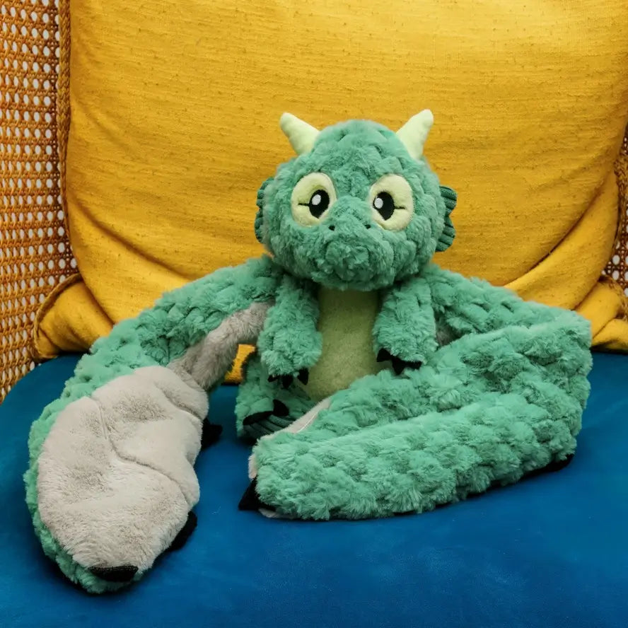 Zephyr the Dragon Hugaround on a yellow and blue chair.