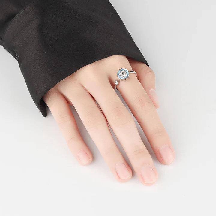 A hand is wearing the silver Evil Eye in 925 Sterling Silver Fidget Ring.