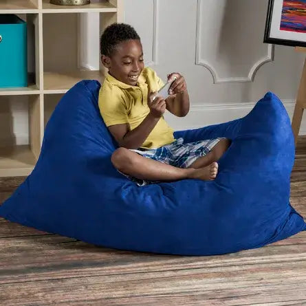 A child sits up on the Jaxx 3.5 ft Saxx Kids Bean Bag.