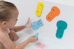 A child arranges Jellyfish Bath Puzzle Pieces in the tub.