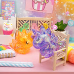 Two Gummy Unicorn Friends sit on a colorful countertop.