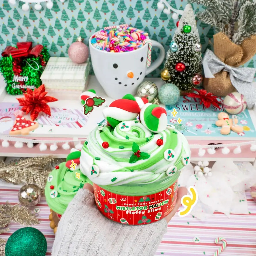The Mistletoe Mallow Fluffy Slime staged next to colorful holiday decorations.