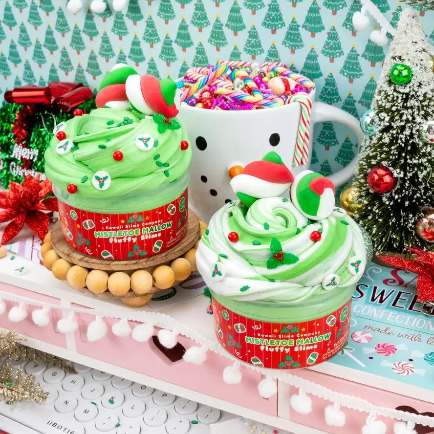 Two of the Mistletoe Mallow Fluffy Slimes sit next to each other on a decorated shelf.