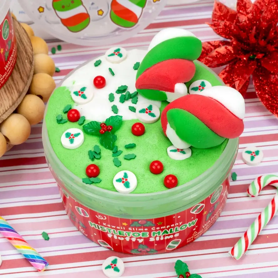 An open jar of the Mistletoe Mallow Fluffy Slime has two marshmallows arranged like a bow.