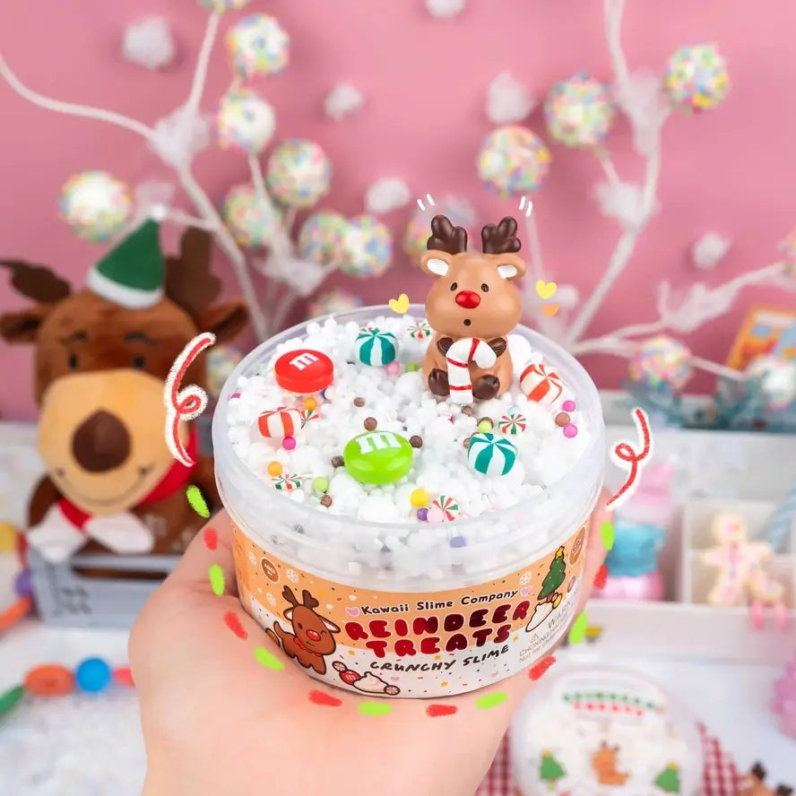 A hand holds up the Reindeer Treats Crunchy Slime.