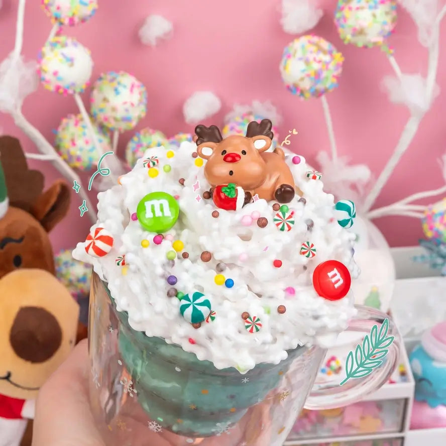 An overflowing cup stylized with white snowflakes is full of Reindeer Treats Crunchy Slime.