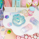 The blue Gummy Kitty Paw Squish next to decorative items.