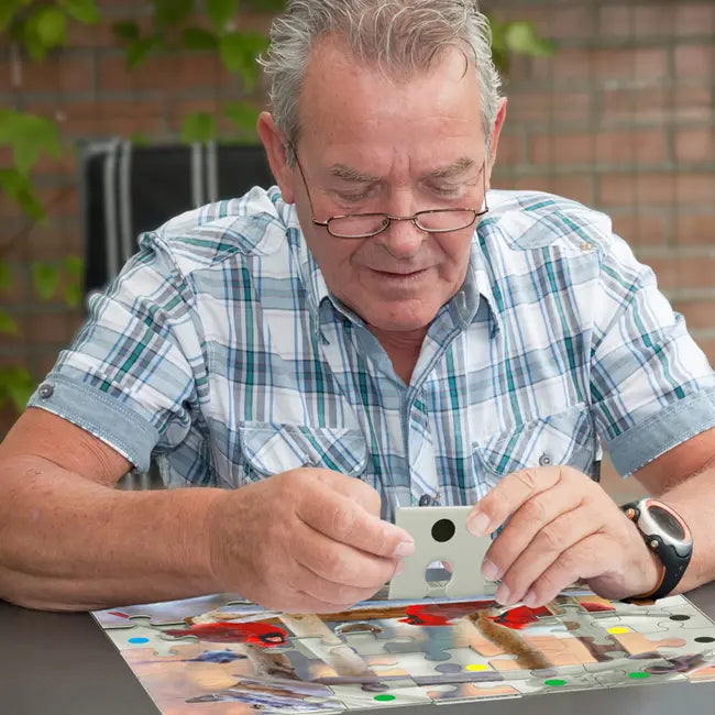 A man picks up a puzzle piece.