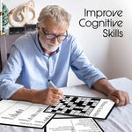 A senior sits at a table with most of a crossword puzzle filled out.
