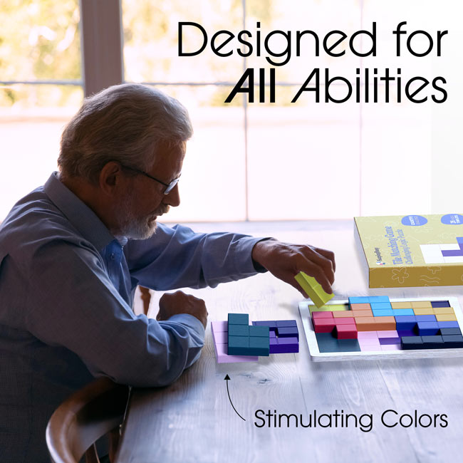 A man sits at a table and places a tile on the Keeping Busy Tile Matching Game for Seniors.