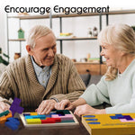 Two seniors smile at each other while they engage with the Keeping Busy Tile Matching Game for Seniors.