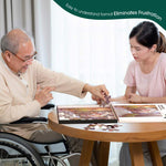 A senior in a wheelchair puts down a puzzle piece while using the box lid as a container for the puzzle.