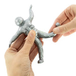 Two hands manipulate the Bendy Space Man.
