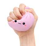 The light pink  Lucky Bao Mystery Squishy Dumpling being squeezed by a hand.