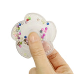 A hand holds the Bead Fidget Spinner.