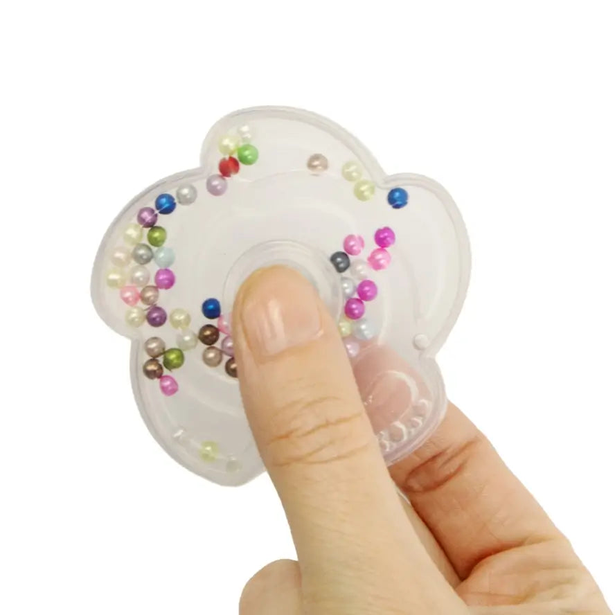 A hand holds the Bead Fidget Spinner.