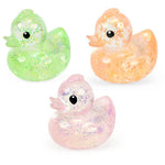Three colors of the glittery Stretchy Glow Ducks.