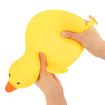 Two hands squeeze the Big Squij Slow Rise Duck.