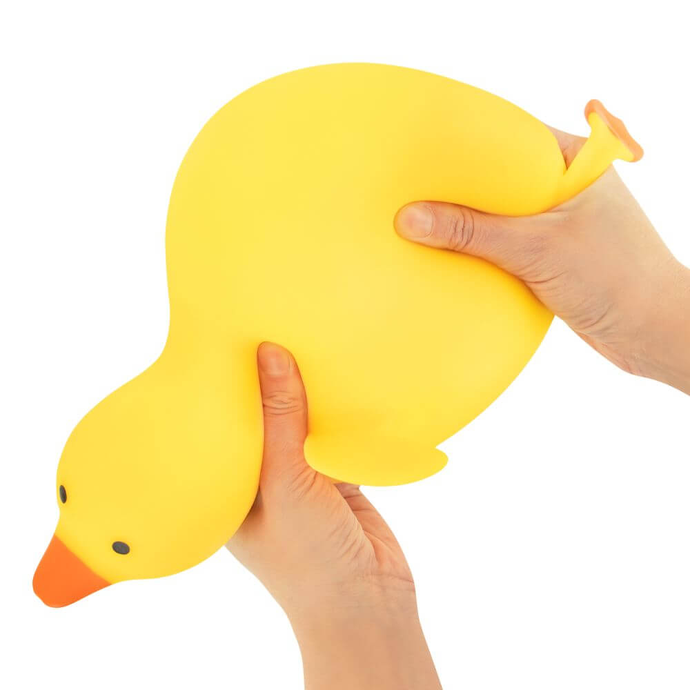 Two hands squeeze the Big Squij Slow Rise Duck.