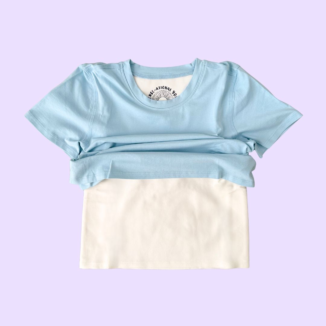 The Light Blue  Kids Compression Lined Sensory T-shirt, with the t-shirt portion raised to reveal the compression undershirt.