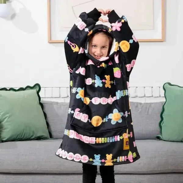 A child poses with their hands over their head while wearing the Kids Friends Forever Hideout Hoodie.