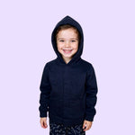 A child smiles with the hood up on their Kids QuietSense™ Sound Reducing Sensory Hoodie in Navy.